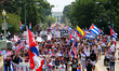 Thousands of demonstrators march from the White House to the Cuban Embassy in Washington,...