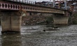 Commuters walk over a brigde during Rainfall in Sopore, District Baramulla Jammu And Kashm...