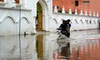 Indian People cross a Flooded street after heavy Monsoon Rains in Pushkar, Rajasthan, Indi...