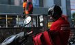 A delivery boy of Zomato, an Indian food-delivery startup, waits outside an outlet to coll...