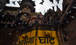 Pigeons fly over the Darbhanga Ghat during rains,on the banks of River Ganges,in Varanasi...