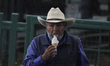 A man consumes an ice cream in front of the area where a column of the Metro Collective Tr...