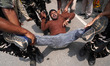 Security personnel detain a member of India's main opposition Congress party during a prot...