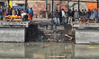 Cremation ghats along the bank of the Bagmati River at Pashupatinath in Kathmandu, Nepal,...