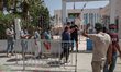 Tunisians queue outside the vaccination centre in the city of Ariana, near the capital Tun...