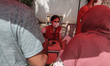 Tunisian Red Crescent volunteers assist citizens waiting for their turn to receive a dose...