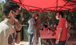 Tunisian Red Crescent volunteers assist citizens waiting for their turn to receive a dose...