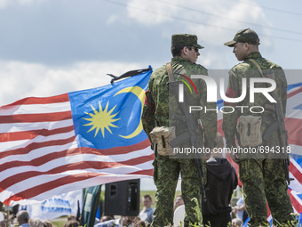 DNR soldiers watche close to a malaysian flag during the celebrations of the anniversary of the tragedy of the malaysian flight MH17 shot do...