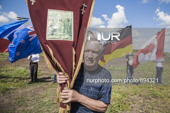 Visitor with a religious icon visit the place where the malaysian flight MH17 fell in the Hrabove village, Ukraine,  during the celebrations...
