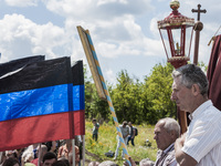 Visitor prays in the place where the malaysian flight MH17 fell in the Hrabove village, Ukraine,  during the celebrations of the anniversary...