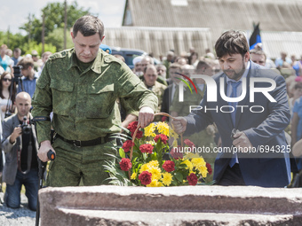 Alexander Zakharchenko and Denish Pushilin leave flowers in the stone memorial for the dead passengers of the tragedy of the malaysian fligh...