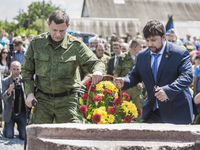 Alexander Zakharchenko and Denish Pushilin leave flowers in the stone memorial for the dead passengers of the tragedy of the malaysian fligh...