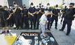 A woman known as "Babcia Kasia" is seen stepping on a banner with a photo of Polish govern...
