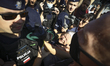 A elderly woman known as "Babcia Kasia" is seen being pushed back by police at the Smolens...