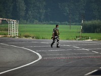 An Indian paramilitary soldier walks on the highway near the site of encounter in south Kashmir's Kulgam area, India on August 13, 2021. Ins...