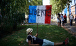 A protester rests on the grass with a placard reading 'Liberty'. Thousands of  protesters...