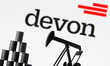 Devon Energy Corporation company logo and miniature models of an oil derrick pump and oil...