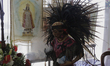 A pre-hispanic dancer performs a ritual with incense and copal on an altar placed outside...