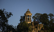 People enjoy the sunset in the Parc des Buttes-Chaumont in Paris, France on July 18, 2021....