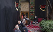 An Iranian cleric (C) delivers a sermon at a historical house in the Grand Bazaar during a...