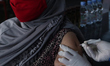 A moslem women receives a dose of the Sinovac vaccine against Covid-19 coronavirus at a th...