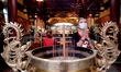 People with face masks pay worship at a temple, amid the global pandemic of Covid-19, in T...