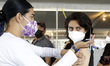 A teenager receives the COVID-19 vaccine booster dose of Pfizer administered inside of Xoc...