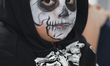 Mexican boy dressed in skeleton make-up while celebrating the Day of the Dead in Toronto,...
