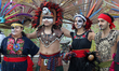 Mexican dancers dressed in Aztec costumes while performing a cultural dance during celebra...
