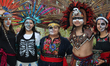 Mexican dancers dressed in Aztec costumes while performing a cultural dance during celebra...