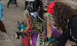 Mexican dancer dressed in an Aztec costume performs a prayer to the spirits of the decease...
