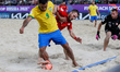 Noel Ott of Switzerland and Rodrigo (L) of Brazil vie for the ball during the FIFA Beach S...