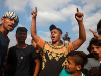 Palestinian protesters react during a demonstration by the border fence with Israel, east of Gaza City, to denounce the Israeli siege of the...
