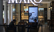 People drink in a outlets coffee as they begin to require that customers eating outdoors w...