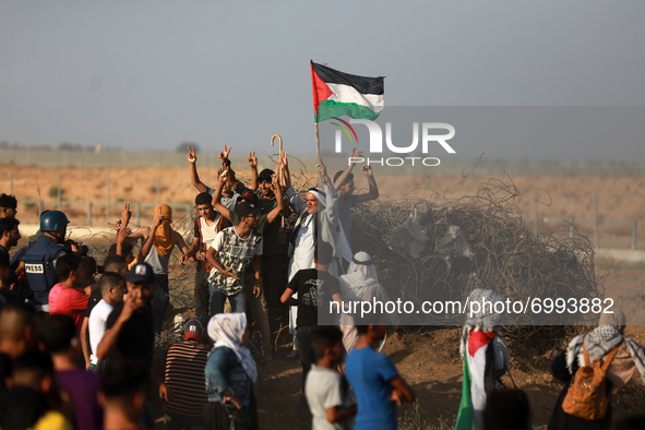 Palestinian demonstrators gather at the Israel-Gaza border fence during a protest in the southern Gaza Strip August 25, 2021. 
 