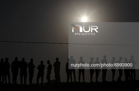 Palestinian demonstrators gather at the Israel-Gaza border fence during a protest in the southern Gaza Strip August 25, 2021. 
 