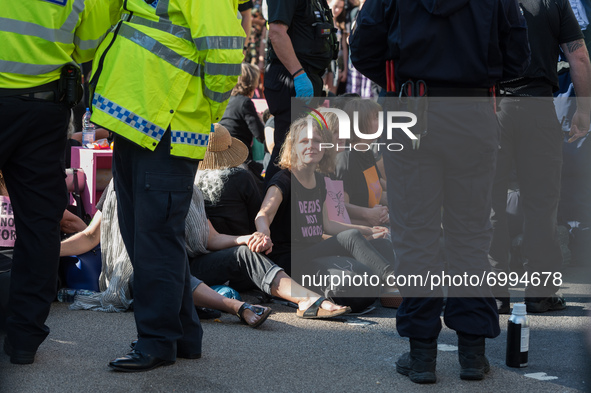 LONDON, UNITED KINGDOM - AUGUST 25, 2021: Environmental activists from Extinction Rebellion block Oxford Circus on the third day of the 'Imp...
