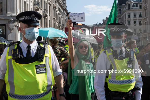 LONDON, UNITED KINGDOM - AUGUST 25, 2021: Environmental activists from Extinction Rebellion block Oxford Circus on the third day of the 'Imp...