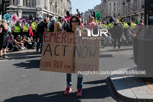 LONDON, UNITED KINGDOM - AUGUST 25, 2021: Environmental activists from Extinction Rebellion demonstrate in Oxford Circus on the third day of...