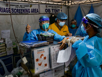 Health workers man the triage area of a hospital placed along a main road in Manila City, Philippines on August 26, 2021. At least two more...