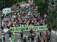 LONDON, UNITED KINGDOM - AUGUST 27, 2021: Environmental activists from Extinction Rebellion march through the City of London in a protest ag...