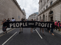 LONDON, UNITED KINGDOM - AUGUST 27, 2021: Environmental activists from Extinction Rebellion march through the City of London in a protest ag...