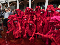 LONDON, UNITED KINGDOM - AUGUST 27, 2021: Extinction Rebellion's Red Brigade demonstrate in Paternoster Square after a march through the Cit...