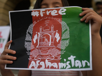 A young protester holds a placard that reads 'Free Afganistan'.
Members of the local Afghan diaspora, activists and local supporters seen in...