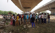 People queue up in line to register themselves to get inoculated with a dose of Covaxin, a...