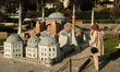 People wander through the permanent exhibition of the miniatures of historical buildings,...