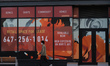 A man wearing a face mask walks past a retail space for lease in Edmonton's Whyte Avenue....