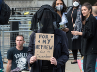LONDON, UNITED KINGDOM - AUGUST 31, 2021: Activists from Extinction Rebellion block the entrance to Downing Street during a funeral march de...