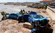 Cars damaged by floods on street filled with mud and derbis the day after flash floods on...