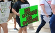 Protestors march from City Hall to the federal court house in protest of the new state abo...